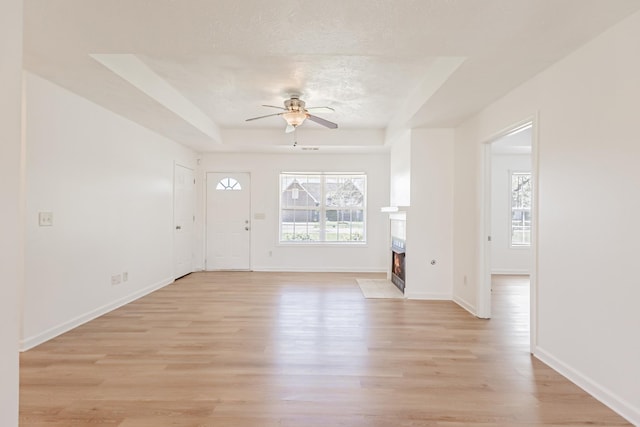 7004 Westfork Dr, Smyrna, TN 37167 - entryway with a ceiling fan, light wood-type flooring, a fireplace with flush hearth, and baseboards