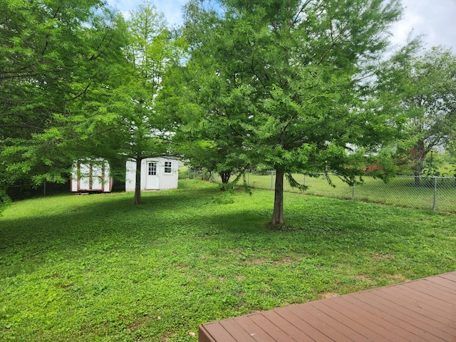 view of yard featuring a shed and an outbuilding