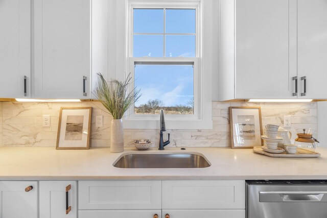 4455 Knox Ln, Cookeville, TN 38506 - kitchen featuring stainless steel dishwasher, a sink, white cabinets, and tasteful backsplash