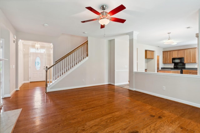 3045 Cairns Dr W, Mount Juliet, TN 37122 - unfurnished living room featuring wood finished floors, ceiling fan, baseboards, and stairway