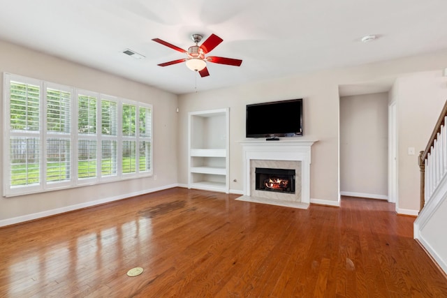 3045 Cairns Dr W, Mount Juliet, TN 37122 - unfurnished living room featuring built in shelves, a high end fireplace, a ceiling fan, and baseboards