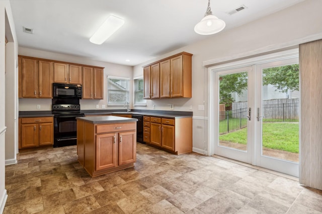 3045 Cairns Dr W, Mount Juliet, TN 37122 - kitchen featuring black appliances, dark countertops, stone finish floors, and brown cabinets