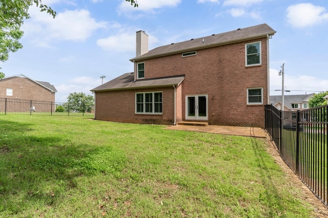 3045 Cairns Dr W, Mount Juliet, TN 37122 - back of property with a chimney, french doors, a patio area, and brick siding