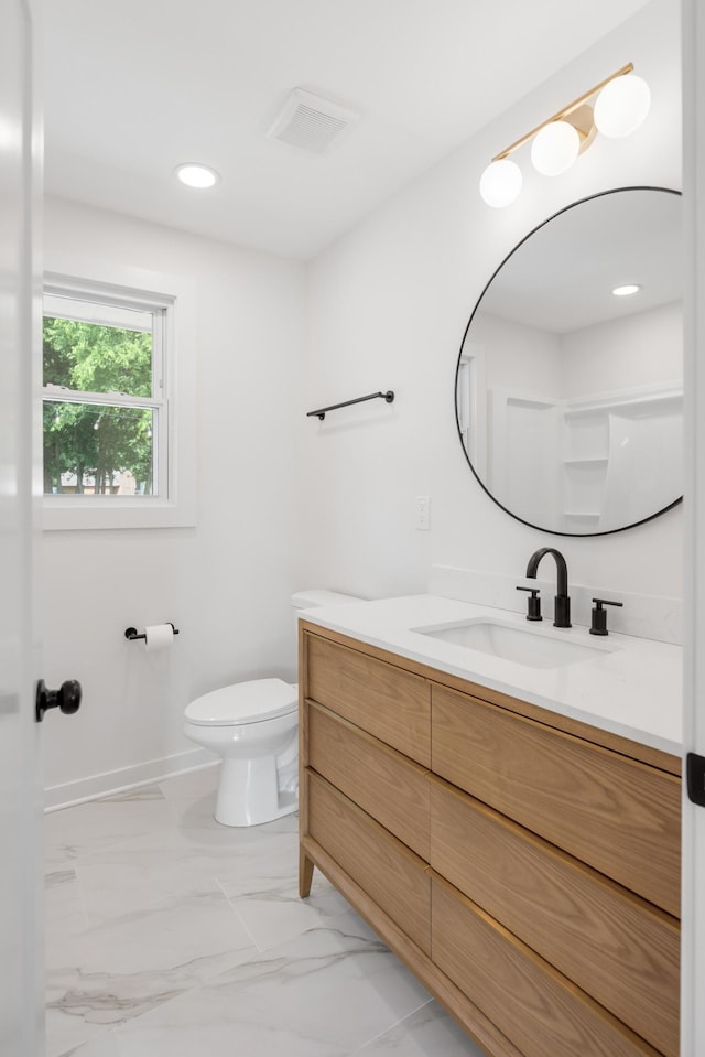 bathroom with toilet, marble look tiles, vanity, baseboards, and recessed lighting