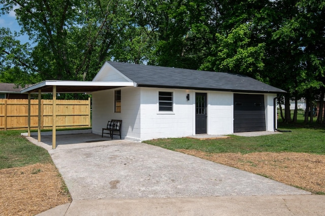 garage with driveway and a carport