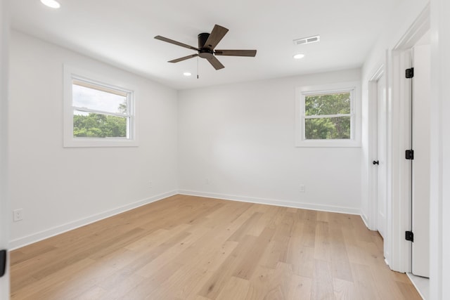 unfurnished room with healthy amount of natural light, light wood finished floors, baseboards, a ceiling fan, and recessed lighting