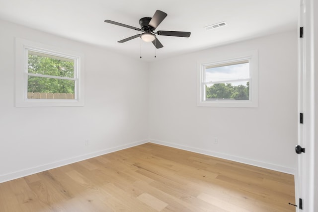 empty room featuring baseboards, light wood-type flooring, and ceiling fan