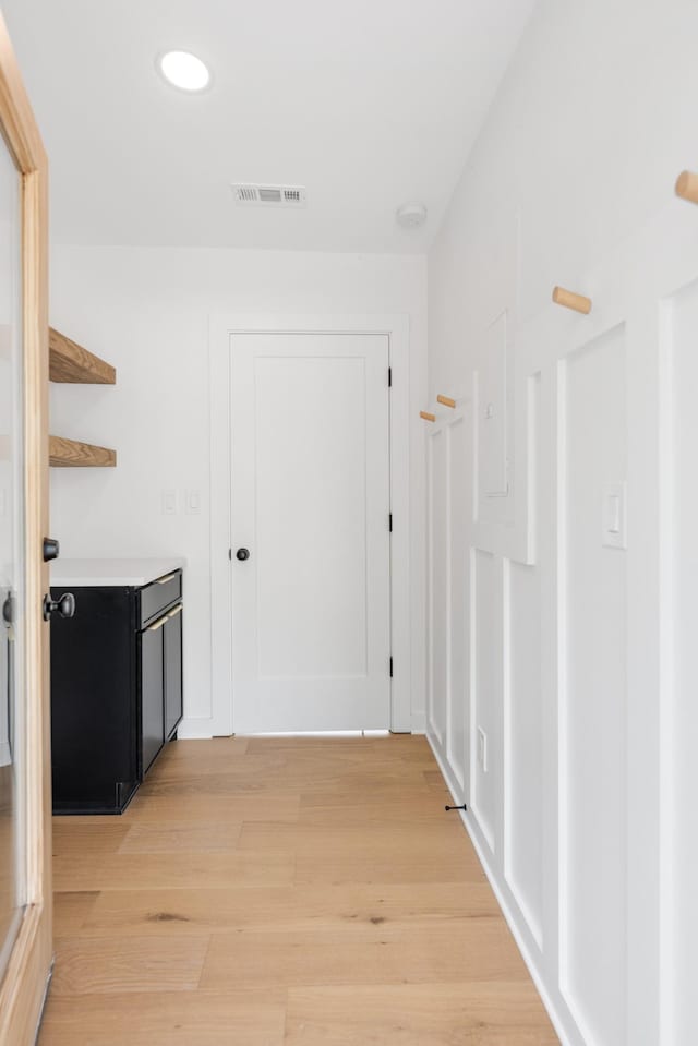 hall featuring light wood-style floors and recessed lighting