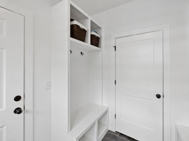 mudroom featuring dark tile patterned flooring
