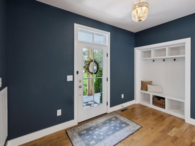 mudroom with wood finished floors and baseboards