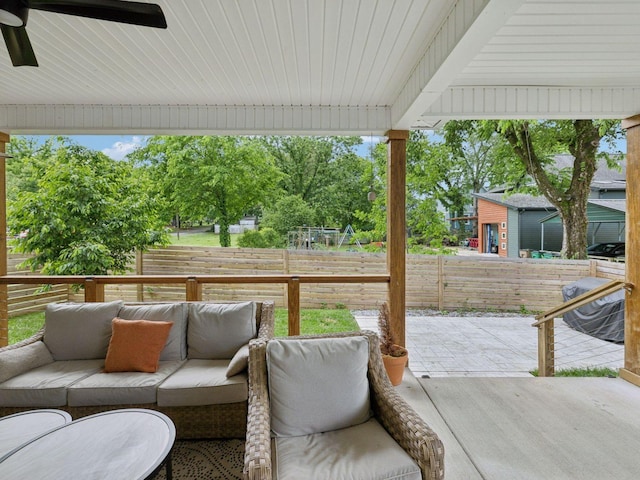 view of patio with an outdoor living space, a ceiling fan, and a fenced backyard