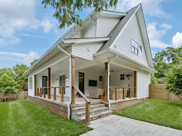 view of front of house featuring a shingled roof and ceiling fan