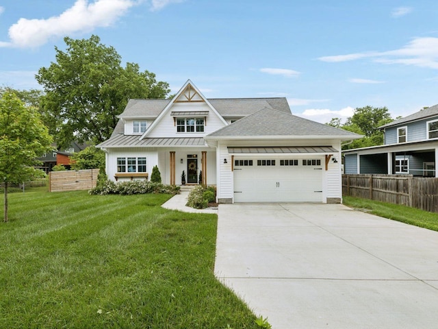 view of front of property featuring a standing seam roof, a garage, concrete driveway, metal roof, and a shingled roof