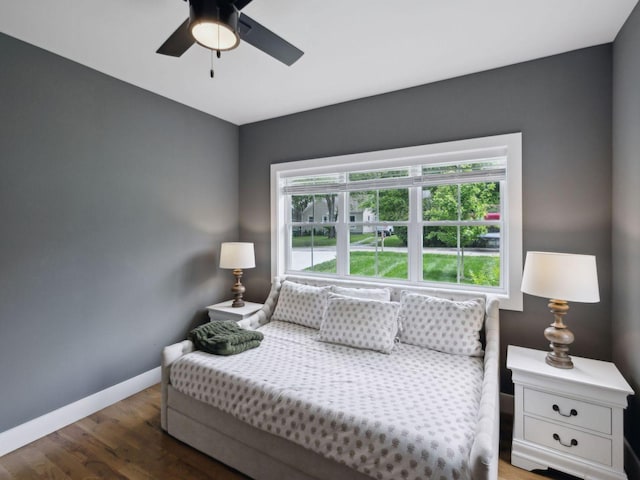 bedroom with wood finished floors, baseboards, and a ceiling fan