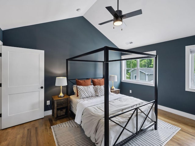 bedroom featuring lofted ceiling, wood finished floors, ceiling fan, and baseboards