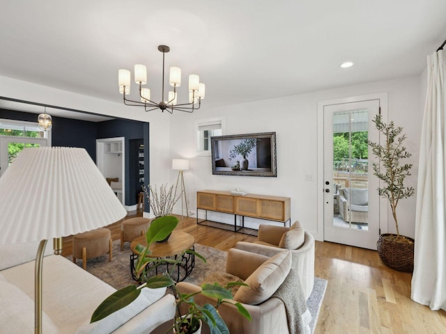 living room featuring plenty of natural light, a chandelier, wood finished floors, and recessed lighting