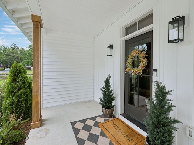 view of exterior entry with covered porch