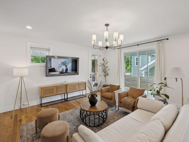 living room with a chandelier, healthy amount of natural light, wood finished floors, baseboards, and recessed lighting