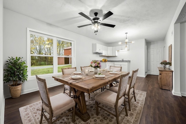 124 Tom Link Rd, Cottontown, TN 37048 - dining area featuring dark wood-style flooring, baseboards, a ceiling fan, and a chandelier