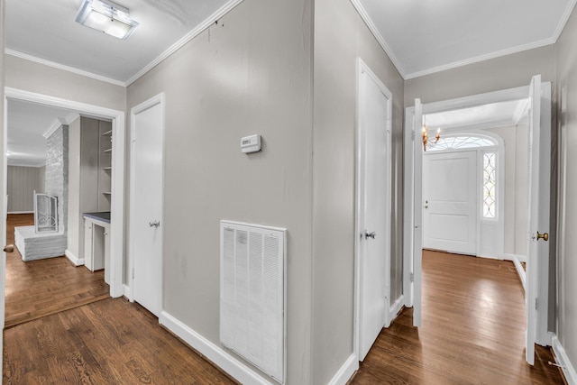 519 S Scott St, Scottsboro, AL 35768 - hall featuring dark wood-style floors, crown molding, a chandelier, and baseboards
