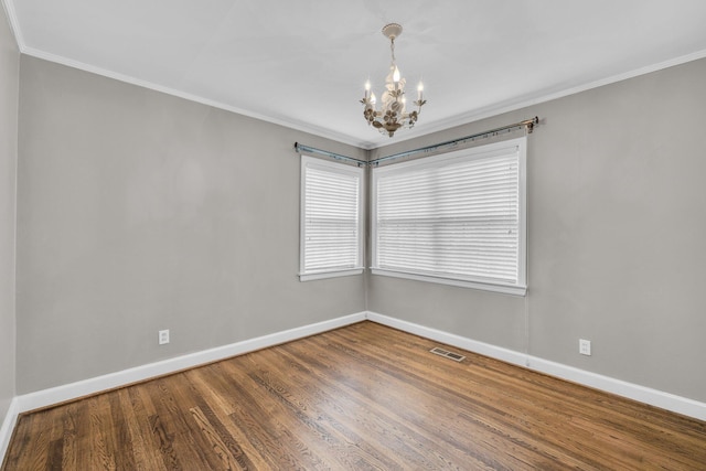 519 S Scott St, Scottsboro, AL 35768 - unfurnished room with a chandelier, baseboards, ornamental molding, and wood finished floors