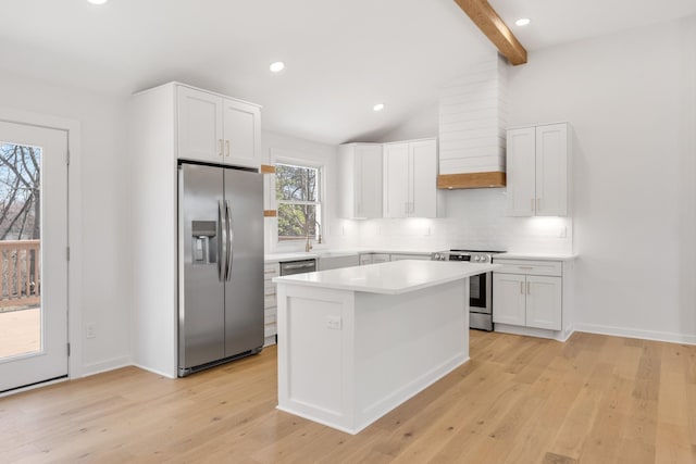 208 Roberta Dr, Hendersonville, TN 37075 - kitchen featuring appliances with stainless steel finishes, tasteful backsplash, light wood-type flooring, white cabinets, and a kitchen island