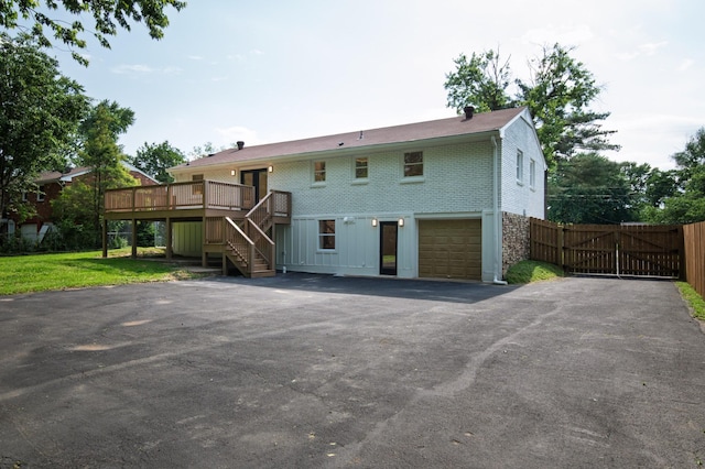 208 Roberta Dr, Hendersonville, TN 37075 - back of house with stairway, a wooden deck, driveway, brick siding, and a garage