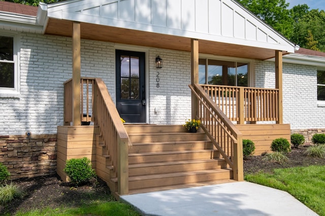 208 Roberta Dr, Hendersonville, TN 37075 - view of exterior entry with brick siding, a porch, and board and batten siding