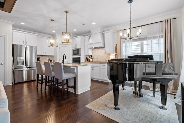 3983 Inlet Loop, Chattanooga, TN 37416 - kitchen with appliances with stainless steel finishes, custom exhaust hood, a chandelier, ornamental molding, and white cabinetry