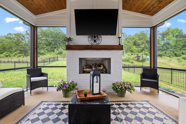 3983 Inlet Loop, Chattanooga, TN 37416 - sunroom featuring a brick fireplace, wood ceiling, vaulted ceiling, healthy amount of natural light, and view of wooded area