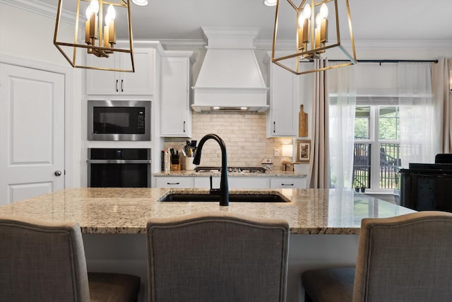 3983 Inlet Loop, Chattanooga, TN 37416 - kitchen featuring a chandelier, oven, custom exhaust hood, built in microwave, and crown molding