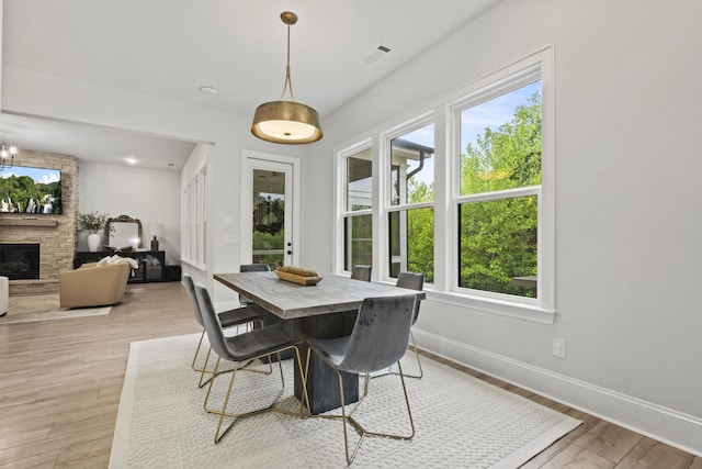 3224 Chase Point Dr, Franklin, TN 37067 - dining area featuring healthy amount of natural light, baseboards, light wood-type flooring, and a stone fireplace