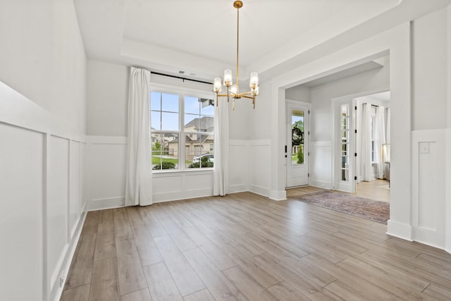 3224 Chase Point Dr, Franklin, TN 37067 - unfurnished dining area featuring a chandelier, plenty of natural light, a decorative wall, light wood finished floors, and wainscoting