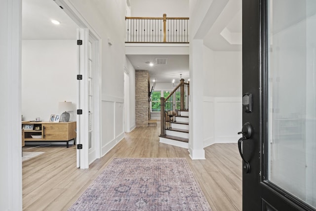 3224 Chase Point Dr, Franklin, TN 37067 - foyer entrance featuring a decorative wall, light wood finished floors, stairs, and a wainscoted wall
