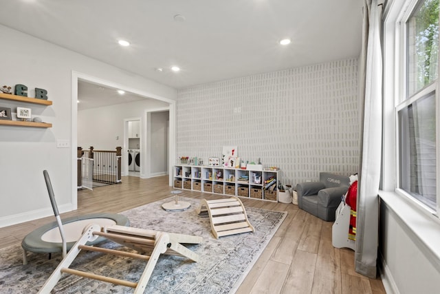 3224 Chase Point Dr, Franklin, TN 37067 - living area featuring light wood-type flooring, washing machine and clothes dryer, recessed lighting, an accent wall, and baseboards