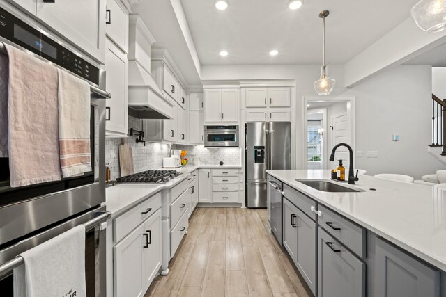 3224 Chase Point Dr, Franklin, TN 37067 - kitchen featuring appliances with stainless steel finishes, a sink, gray cabinets, light countertops, and backsplash