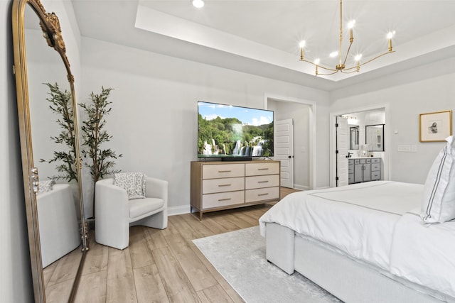 3224 Chase Point Dr, Franklin, TN 37067 - bedroom featuring a tray ceiling, a chandelier, light wood finished floors, ensuite bath, and baseboards
