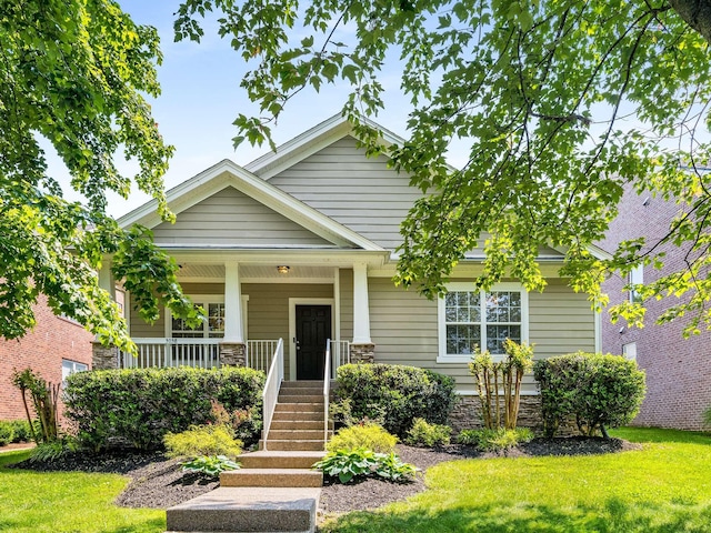 3038 Oxford Glen Dr, Franklin, TN 37067 - view of front of house with a front lawn, covered porch, stone siding, and stairway