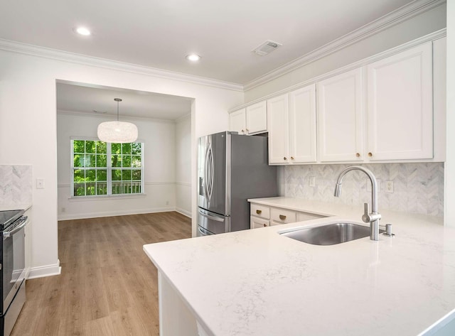 3038 Oxford Glen Dr, Franklin, TN 37067 - kitchen with a sink, appliances with stainless steel finishes, white cabinets, light wood-style flooring, and crown molding