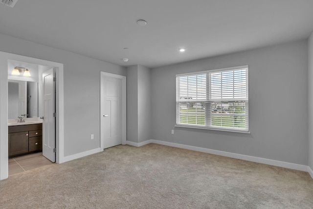 1610 Shenstone Dr, Smyrna, TN 37167 - unfurnished bedroom with light colored carpet, baseboards, a sink, recessed lighting, and ensuite bathroom