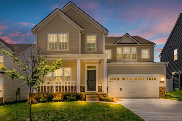 1610 Shenstone Dr, Smyrna, TN 37167 - view of front of property with covered porch, driveway, stone siding, an attached garage, and a front lawn