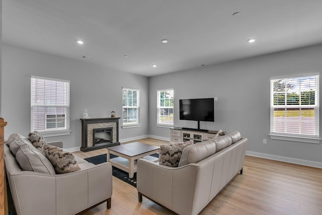 1610 Shenstone Dr, Smyrna, TN 37167 - living area with light wood-style floors, a stone fireplace, baseboards, and recessed lighting