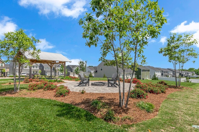1610 Shenstone Dr, Smyrna, TN 37167 - view of grassy yard featuring a residential view, a gazebo, a fire pit, and a patio area