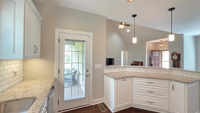109 Coteswood Ct, Columbia, TN 38401 - kitchen with ceiling fan, backsplash, vaulted ceiling, white cabinets, and light stone counters