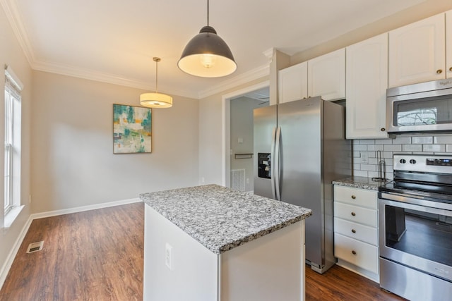 664 Huffine Manor Cir, Franklin, TN 37067 - kitchen featuring stainless steel appliances, a center island, light stone countertops, ornamental molding, and dark wood finished floors