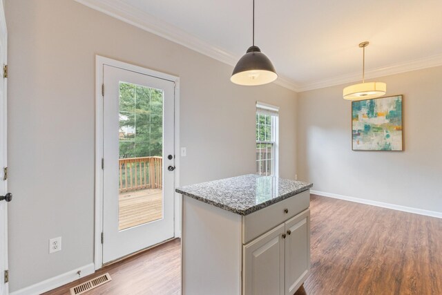 664 Huffine Manor Cir, Franklin, TN 37067 - kitchen featuring light wood-style flooring, crown molding, decorative light fixtures, and light stone counters