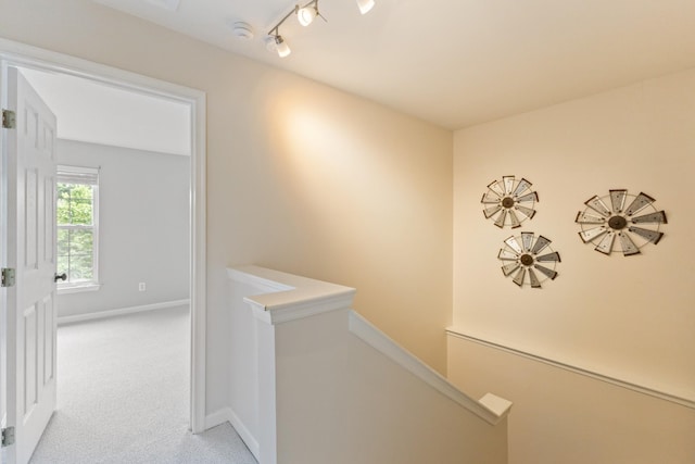 664 Huffine Manor Cir, Franklin, TN 37067 - hall with an upstairs landing, carpet floors, rail lighting, and baseboards