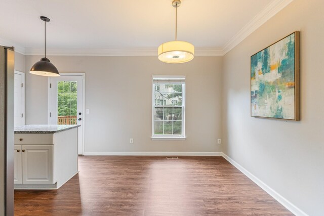 664 Huffine Manor Cir, Franklin, TN 37067 - unfurnished dining area with crown molding, dark wood-type flooring, and baseboards