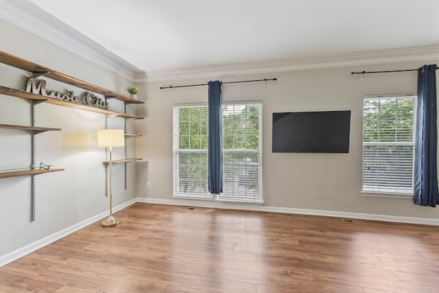 664 Huffine Manor Cir, Franklin, TN 37067 - empty room with healthy amount of natural light, ornamental molding, wood finished floors, and baseboards
