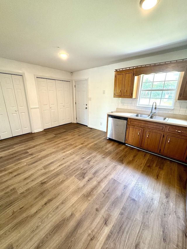 1306 Jared Ct, Clarksville, TN 37042 - kitchen with a sink, stainless steel dishwasher, dark wood finished floors, brown cabinetry, and tasteful backsplash
